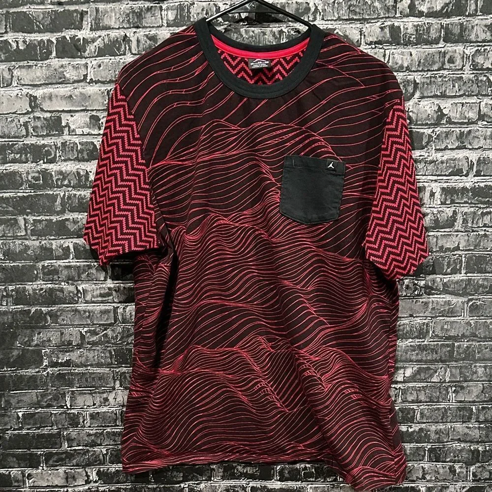 Jordan men's tee in red and black with a unique all-over pattern and a pocket.